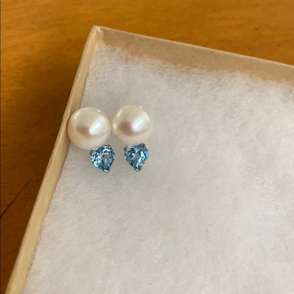 Pearl earrings with blue gem attached